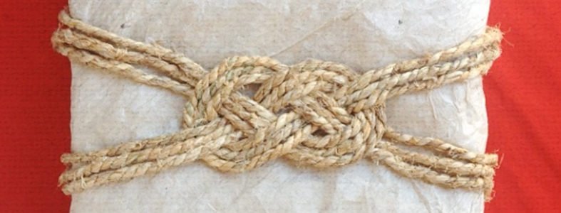 how to wrap a gift and finish it with a decorative knot